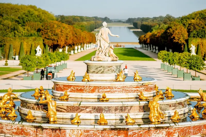 Latona Fountain with gilded figures looking down the Grand Canal at Versailles in autumn